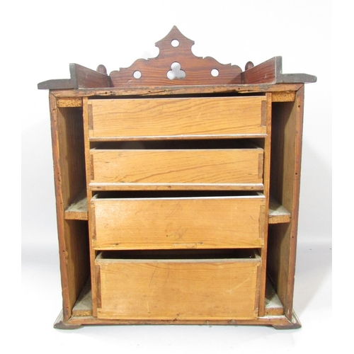 535A - A Victorian pitch pine cabinet, with acorn finials to the cornice over two panelled doors flanked by... 