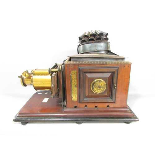 536A - A Victorian Triumph Magic Lantern slide projector on a mahogany plinth.