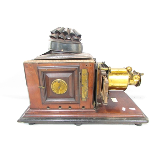 536A - A Victorian Triumph Magic Lantern slide projector on a mahogany plinth.