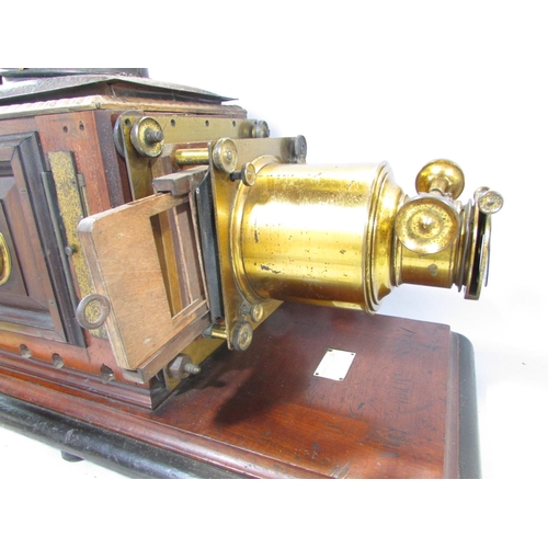 536A - A Victorian Triumph Magic Lantern slide projector on a mahogany plinth.