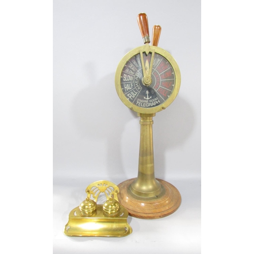 538A - A brass ship’s engine room Telegraph set on a circular wood base, still in working, 53cm tall togeth... 