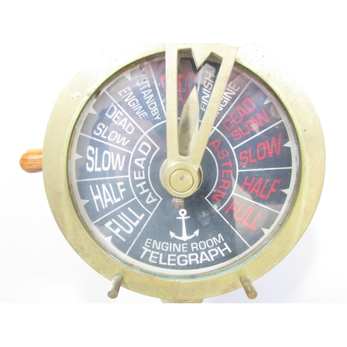 538A - A brass ship’s engine room Telegraph set on a circular wood base, still in working, 53cm tall togeth... 