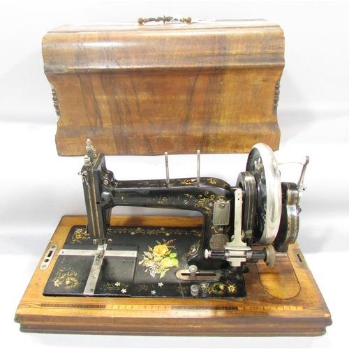 543A - A German Winnselmann manually operated sewing machine, with floral decorations with its original woo... 