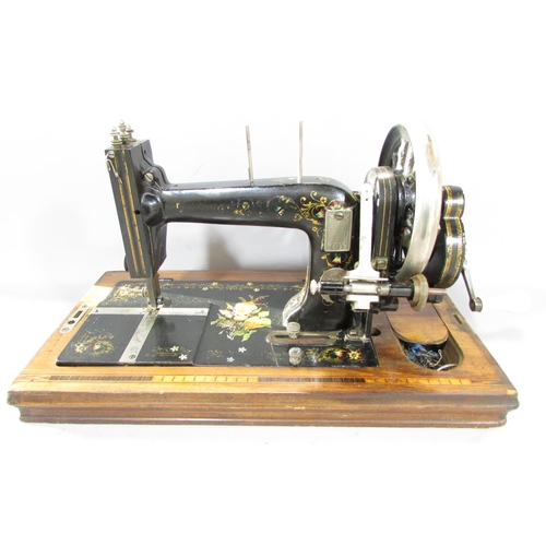 543A - A German Winnselmann manually operated sewing machine, with floral decorations with its original woo... 