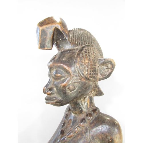 643A - An African carving in the Congolese style of a woman breast feeding a baby, 66cm high.