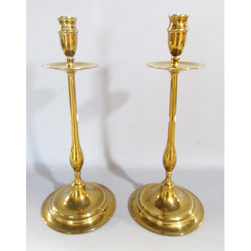 648C - A pair of 19th century brass candlesticks with slender column supports