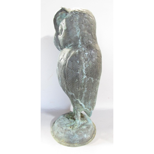 649A - A copper wise old owl with eyebrows, in a weathered verdigris finish, raised on a domed dais, 43cm h... 