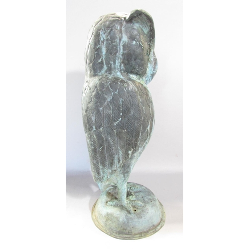 649A - A copper wise old owl with eyebrows, in a weathered verdigris finish, raised on a domed dais, 43cm h... 