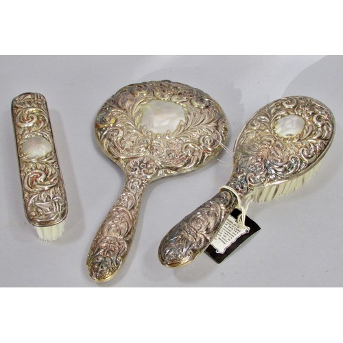 232 - An early 20th century silk lined box with a silver hair brush set, a hand mirror, hair and clothes b... 