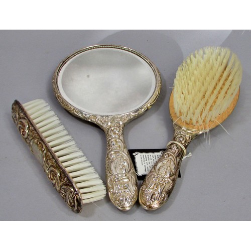 232 - An early 20th century silk lined box with a silver hair brush set, a hand mirror, hair and clothes b... 