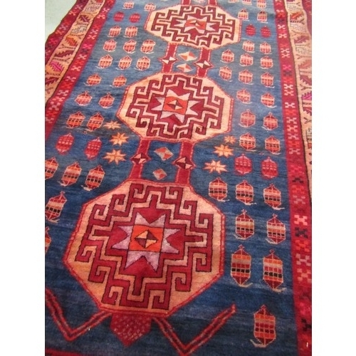 1567 - A corridor rug of Persian design with five interlocking hexagonal medallions on a blue ground 404cm ... 