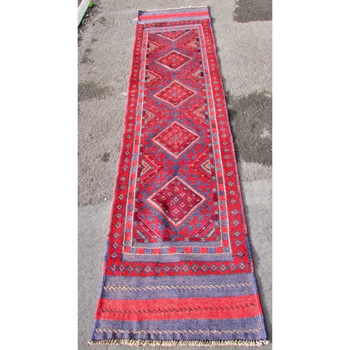 1547 - A Meshwani runner, with a red and blue repeating diamond pattern 250 x 59 cm