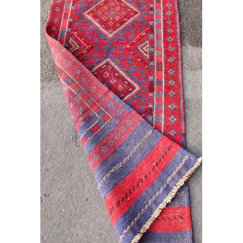 1547 - A Meshwani runner, with a red and blue repeating diamond pattern 250 x 59 cm