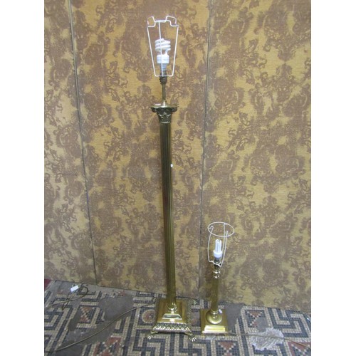 1290 - A polished brass effect standard lamp in the form of a Corinthian column with stepped base and lion’... 