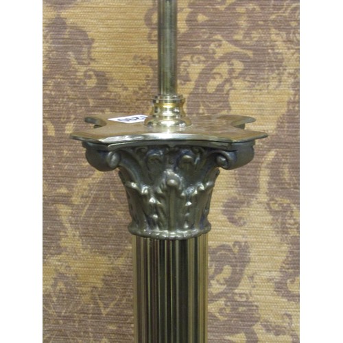 1290 - A polished brass effect standard lamp in the form of a Corinthian column with stepped base and lion’... 