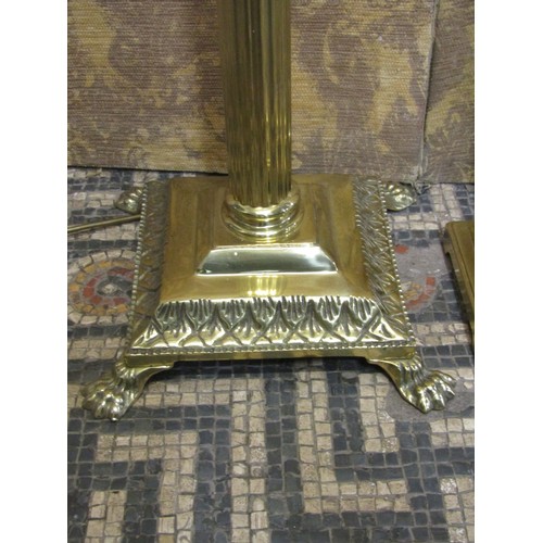 1290 - A polished brass effect standard lamp in the form of a Corinthian column with stepped base and lion’... 