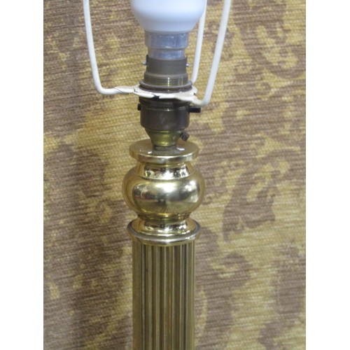 1290 - A polished brass effect standard lamp in the form of a Corinthian column with stepped base and lion’... 