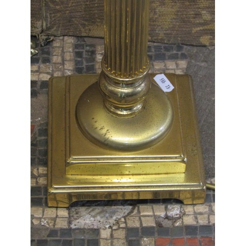 1290 - A polished brass effect standard lamp in the form of a Corinthian column with stepped base and lion’... 