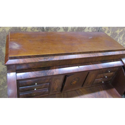 1211A - 19th century continental mahogany cylinder bureau, enclosing a fitted interior of drawers, pigeon ho... 