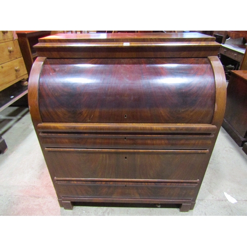 1211A - 19th century continental mahogany cylinder bureau, enclosing a fitted interior of drawers, pigeon ho... 