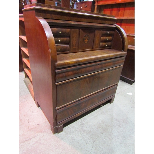 1211A - 19th century continental mahogany cylinder bureau, enclosing a fitted interior of drawers, pigeon ho... 