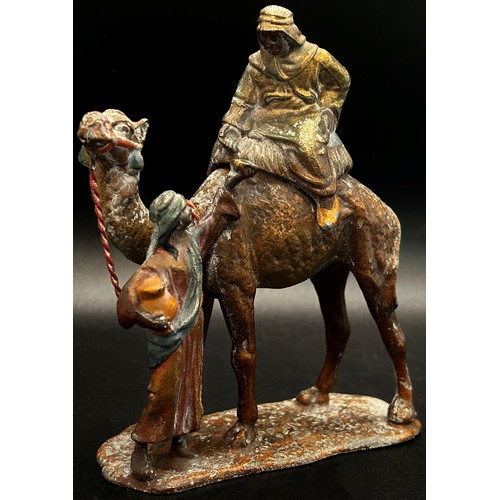 456 - Two painted spelter groups comprising a cold painted camel and attendant and a further worshipper up... 