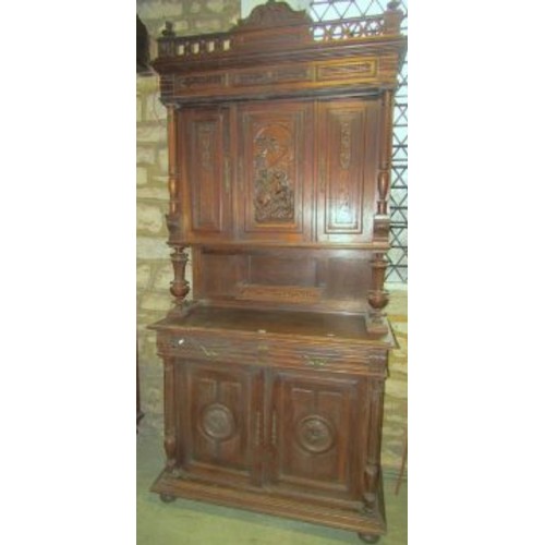 1291 - Continental oak buffet, the lower section enclosed by a pair of carved panelled doors beneath two fr... 