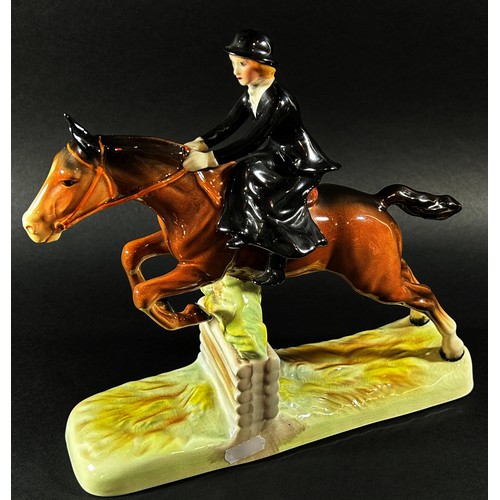 59 - A Beswick equestrian figure group of a woman riding side saddle jumping a fence