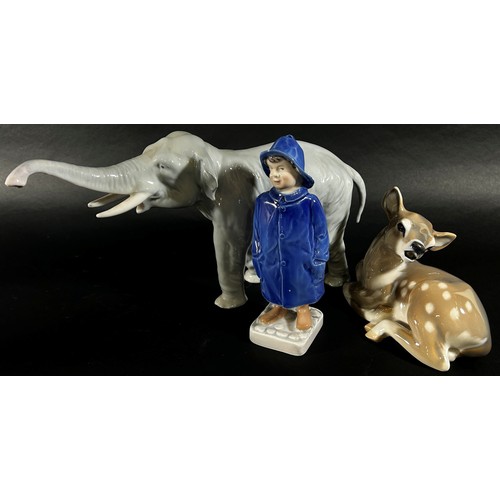 70 - Three Royal Copenhagen porcelain figures to include an elephant, a deer and a boy (3)