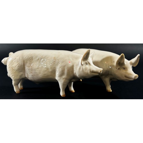 71 - A collection of Beswick porcelain animals to include two pigs, a ewe and three lambs