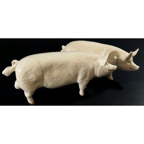 71 - A collection of Beswick porcelain animals to include two pigs, a ewe and three lambs