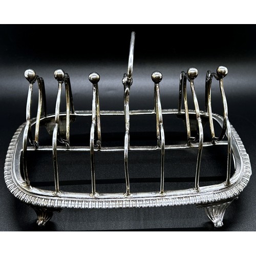 172 - A George III silver toast rack with six heart shaped divisions, gadrooned base on scrolled feet, Lon... 