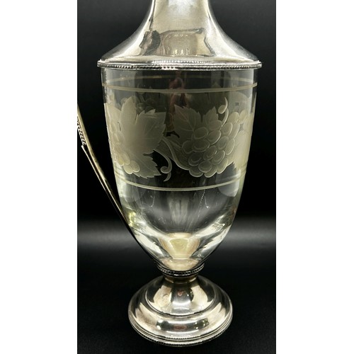 174 - A Regency style silver and glass claret jug with etched grape and vine decoration and a beaded handl... 