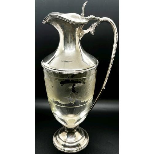 174 - A Regency style silver and glass claret jug with etched grape and vine decoration and a beaded handl... 