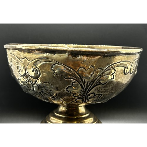 175 - A late Victorian silver sugar bowl decorated with a rural milking scene, raised on three lion mask p... 