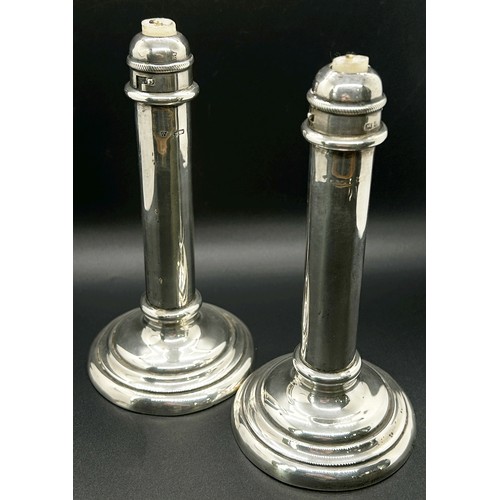 177 - A pair of students silver sprung candlesticks, Birmingham 1903, makers mark rubbed, together with a ... 