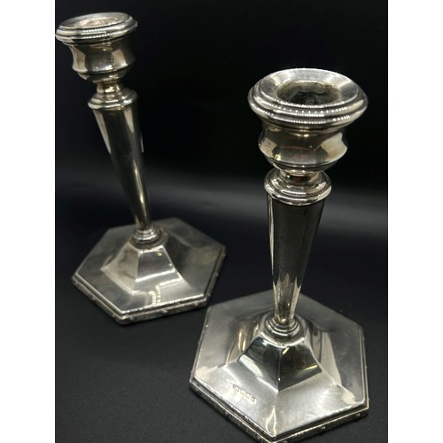 177 - A pair of students silver sprung candlesticks, Birmingham 1903, makers mark rubbed, together with a ... 