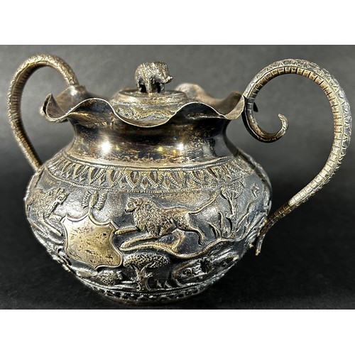 179 - A middle eastern silver metal bowl with cover and serpent handles decorated with lions, gazelles and... 