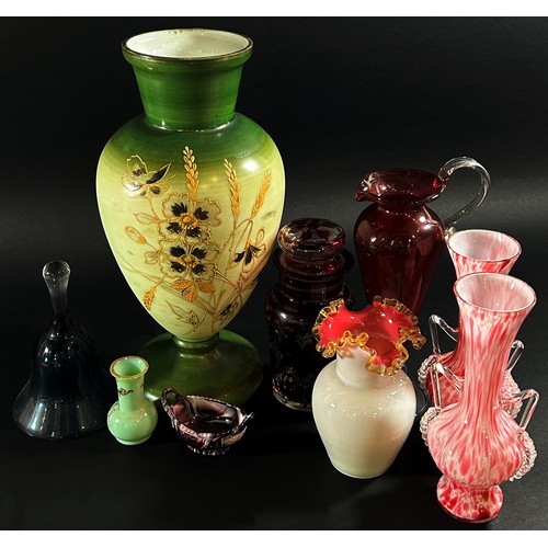 124 - A miscellaneous collection of glass to include a slender Cranberry jug, a pair of Murano pink mottle... 