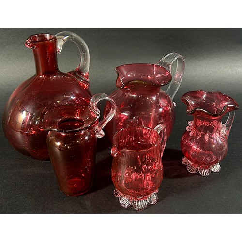 125 - Ten Victorian Cranberry glass items to include water jugs, milk jugs, crimped edged sugar bowls etc.