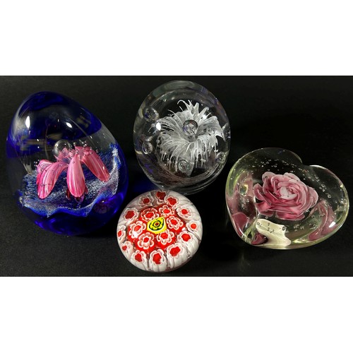 134 - A collection of glass paperweights to include a Caithness ‘Fae Pink’ example with box, two exotic fi... 