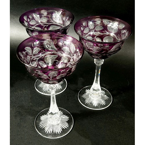 146 - Three coloured cut glasses and three coloured hock glasses and a claret jug and a wine coaster