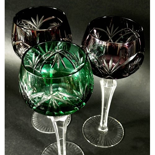 146 - Three coloured cut glasses and three coloured hock glasses and a claret jug and a wine coaster