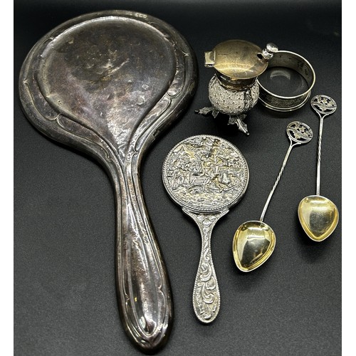 201 - A quantity of silver including a hand mirror, napkin ring, two souvenir spoons, thistle salt pot and... 