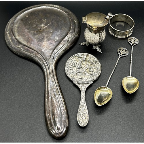 201 - A quantity of silver including a hand mirror, napkin ring, two souvenir spoons, thistle salt pot and... 