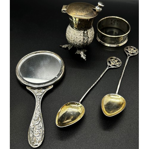 201 - A quantity of silver including a hand mirror, napkin ring, two souvenir spoons, thistle salt pot and... 