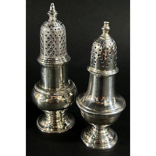 202 - A mixed selection of silver consisting of two pepper pots, two bud vases, letter knife, a pair of se... 