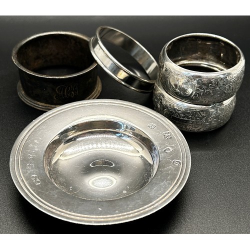 188 - A selection of silver ware including four napkin rings, a small Armada dish, a caddy spoon and a sce... 