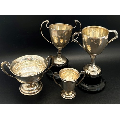 167 - Four small silver trophies, a silver jar lid, two silver spoons, a napkin ring and a bracelet, 8 oz ... 