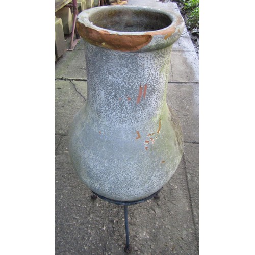 1010 - A small chimenea raised on a simple steel stand (af), 66 cm high